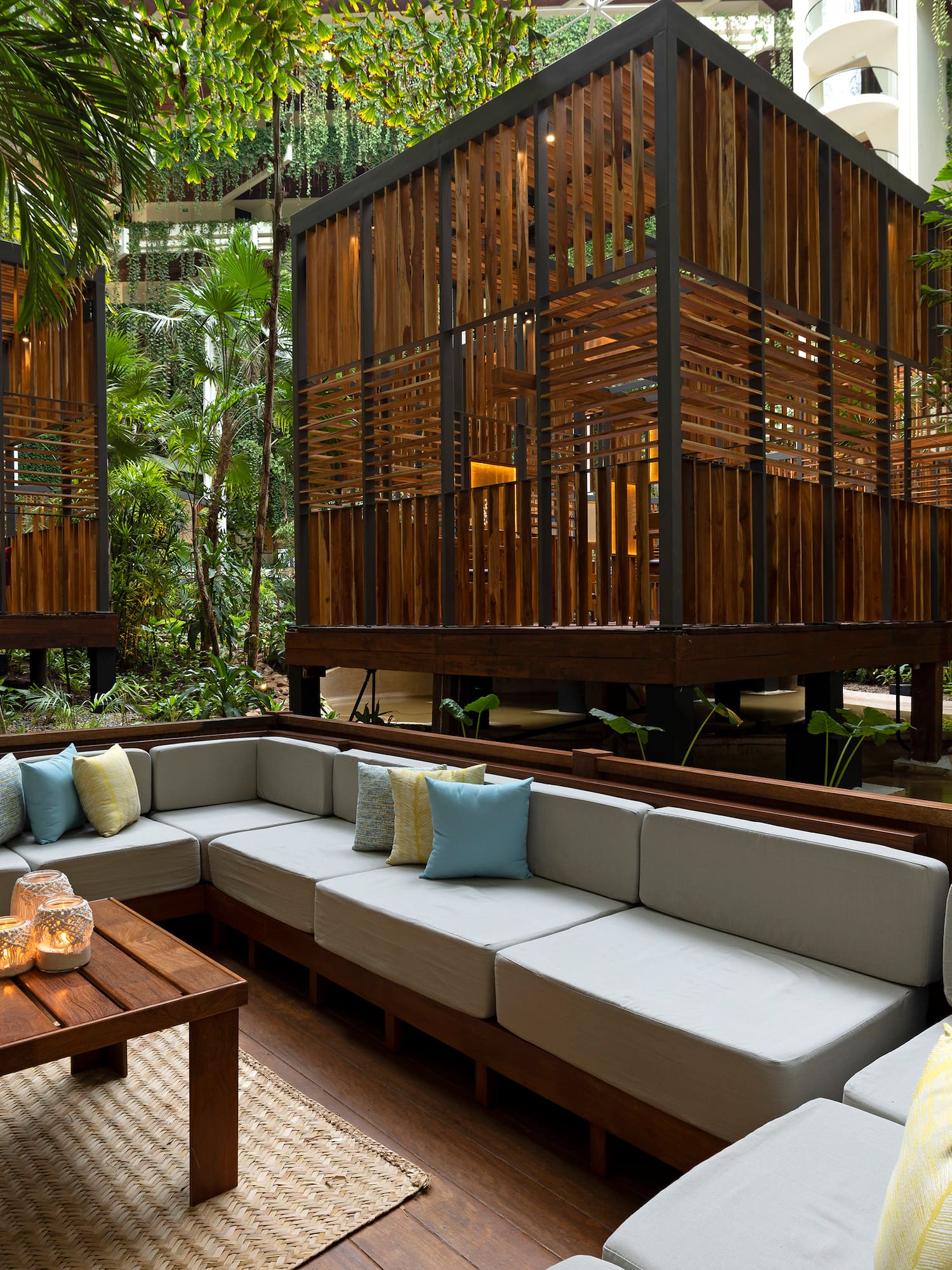 a patio area with a wood structure and a wooden table