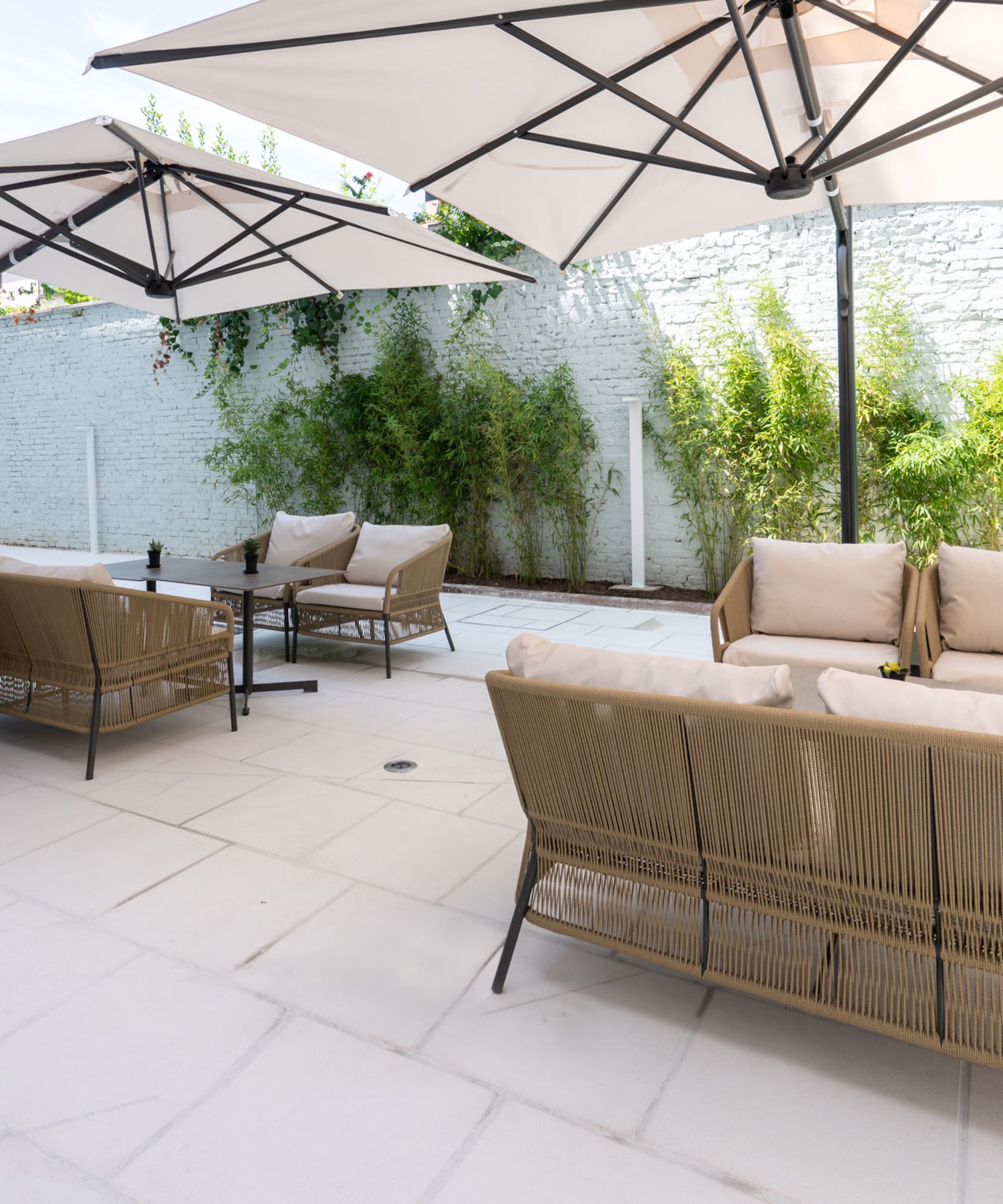 a patio with chairs and umbrellas