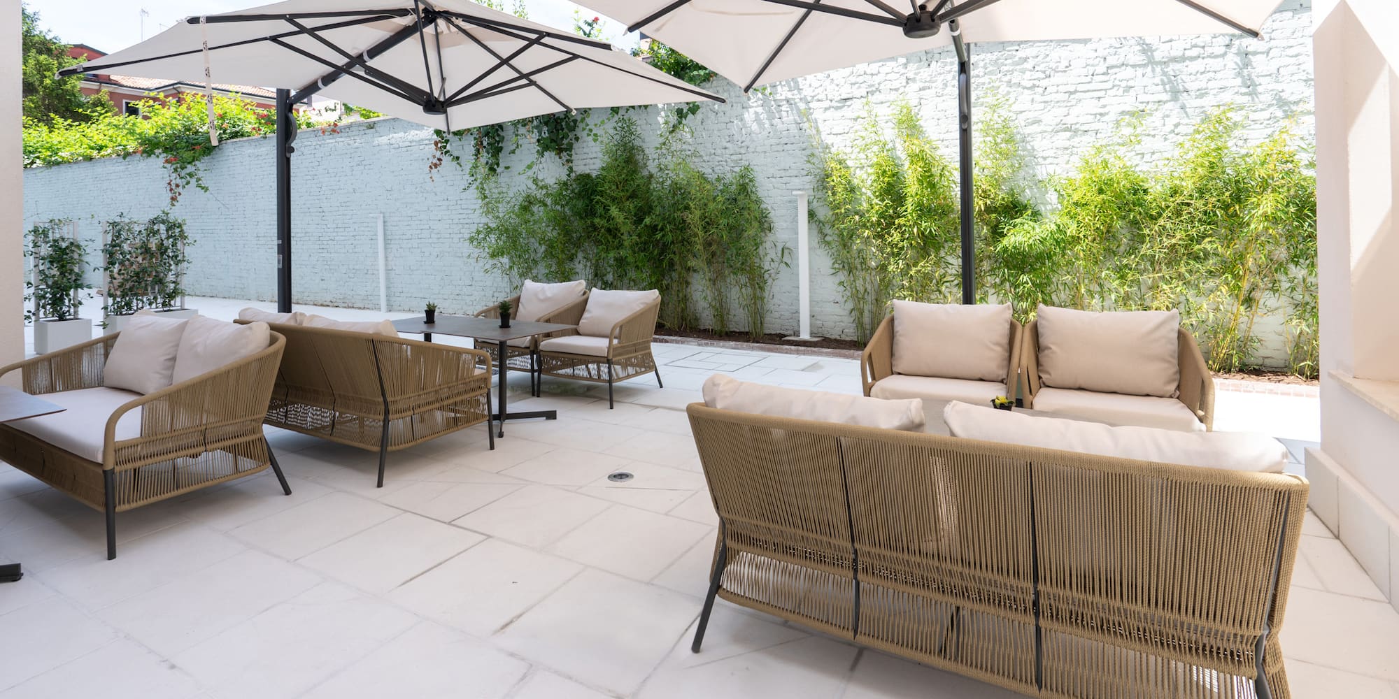a patio with chairs and umbrellas