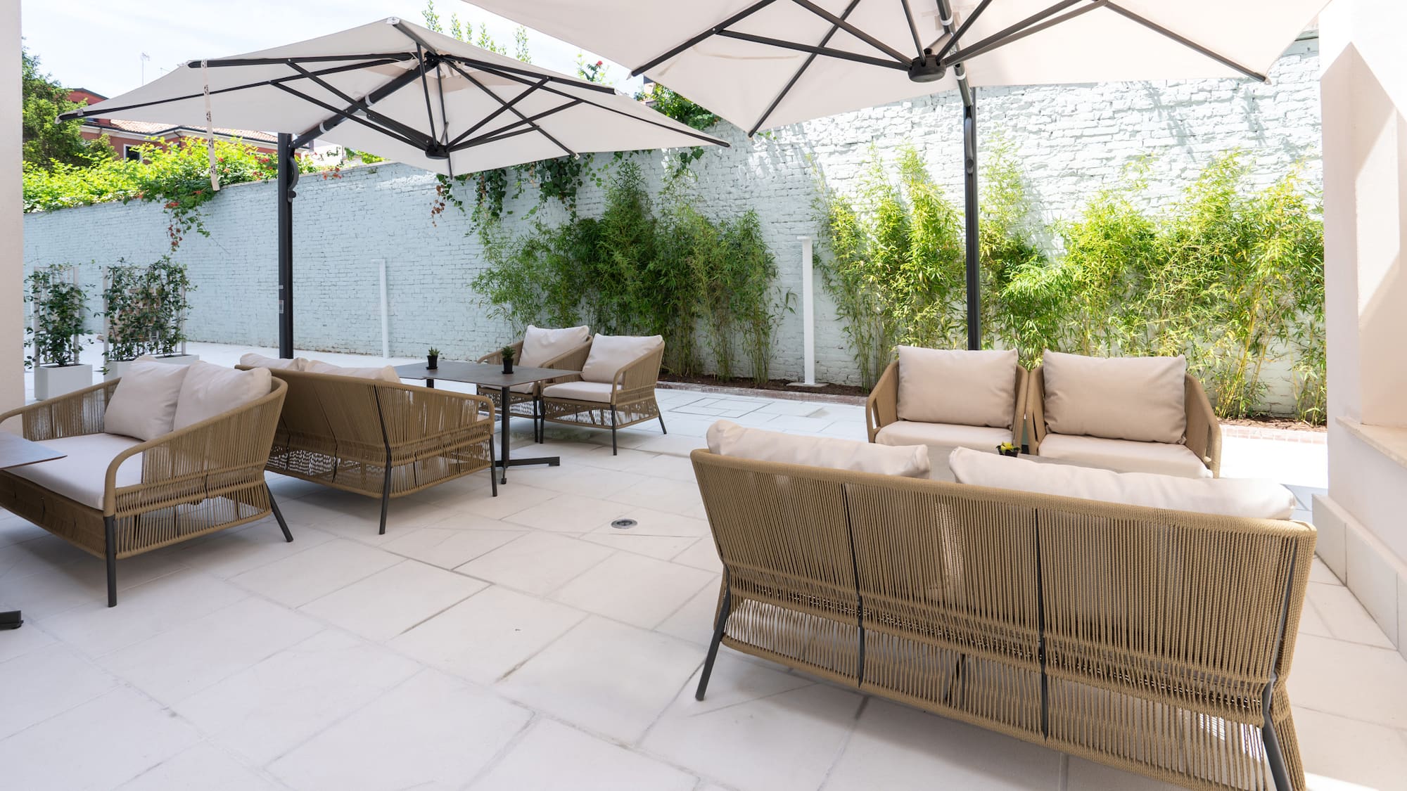 a patio with chairs and umbrellas