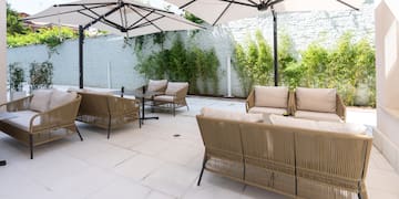 a patio with chairs and umbrellas
