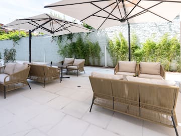 a patio with chairs and umbrellas