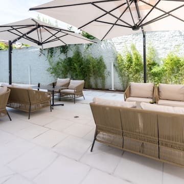 a patio with chairs and umbrellas