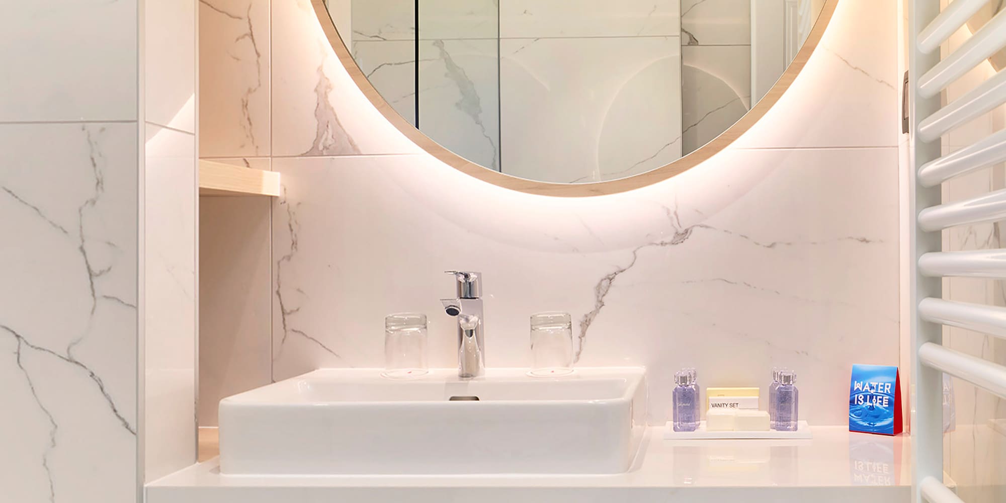 a bathroom with a round mirror