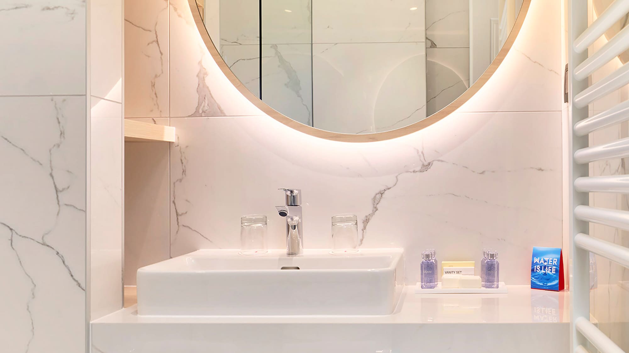 a bathroom with a round mirror