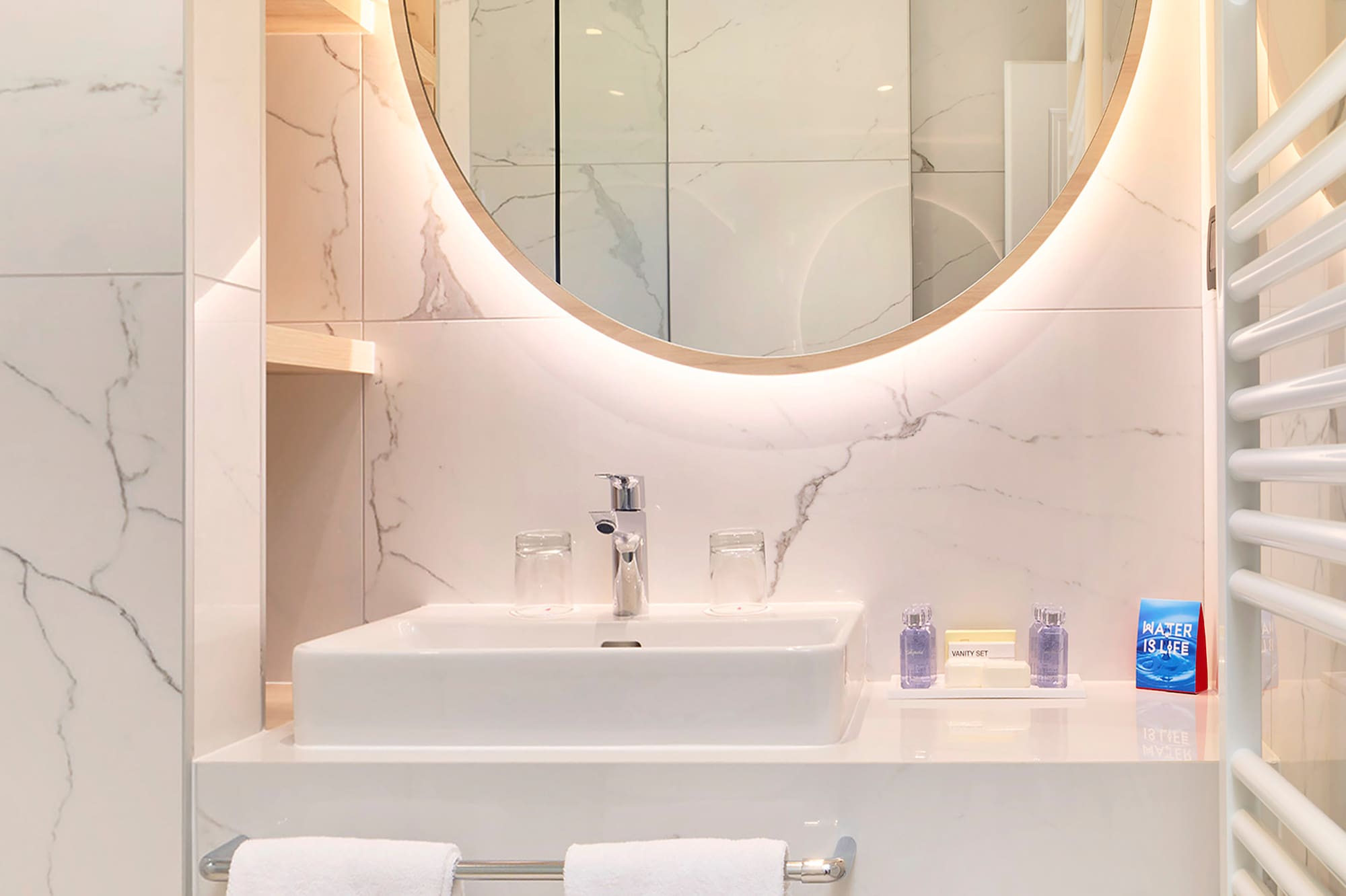 a bathroom with a round mirror