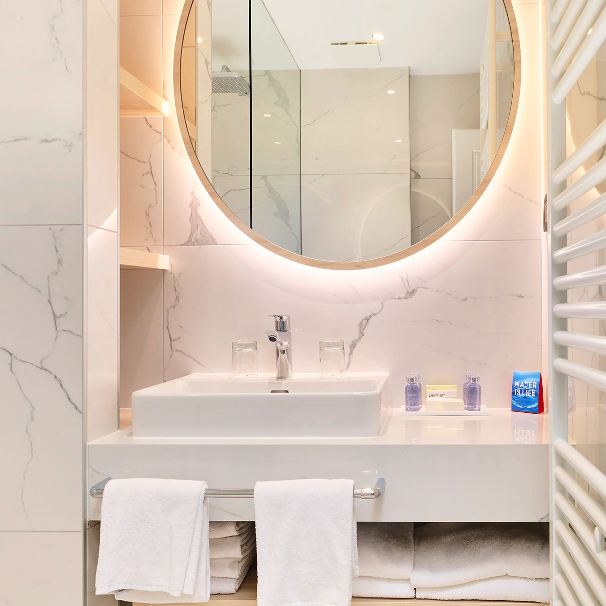 a bathroom with a round mirror