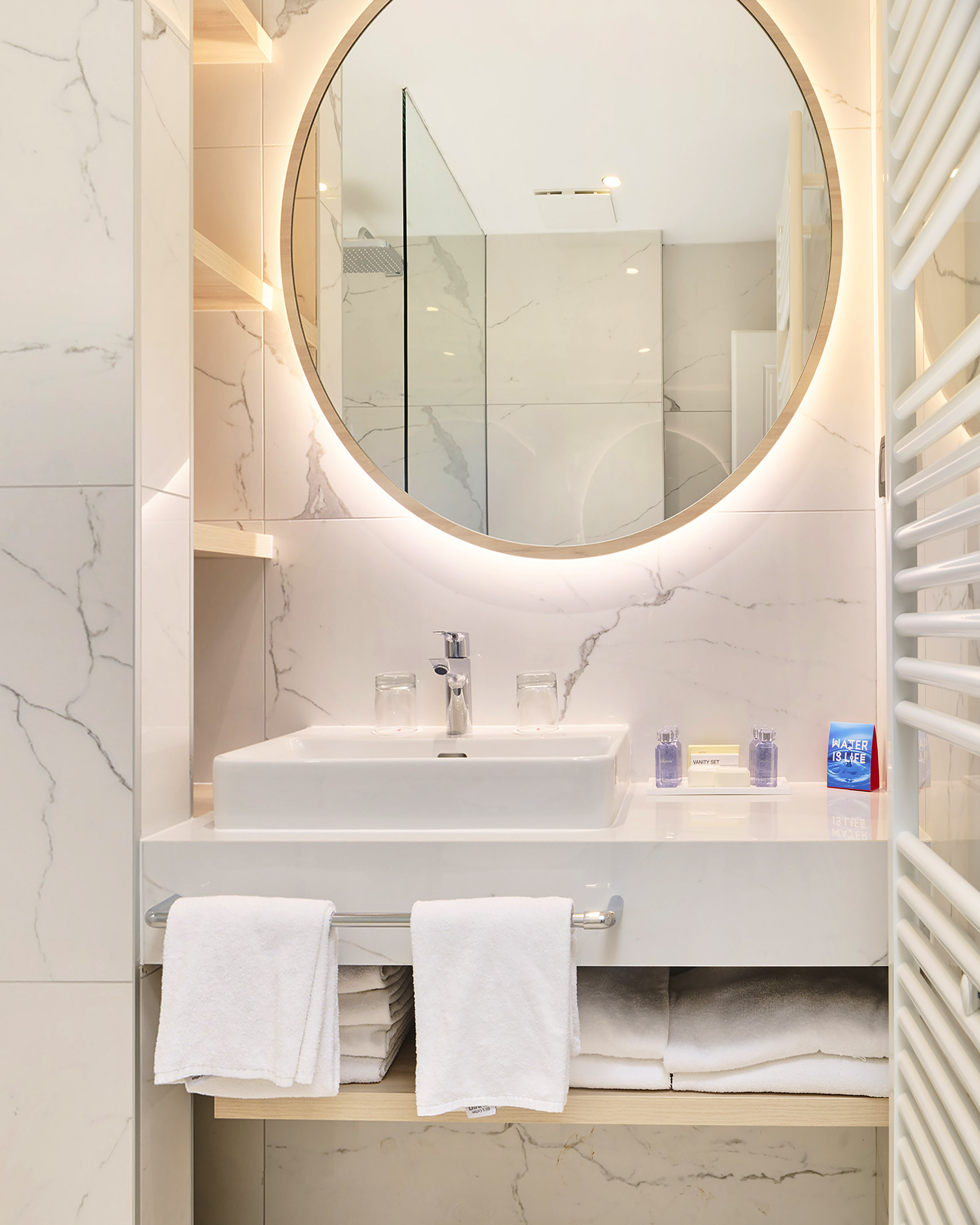 a bathroom with a round mirror