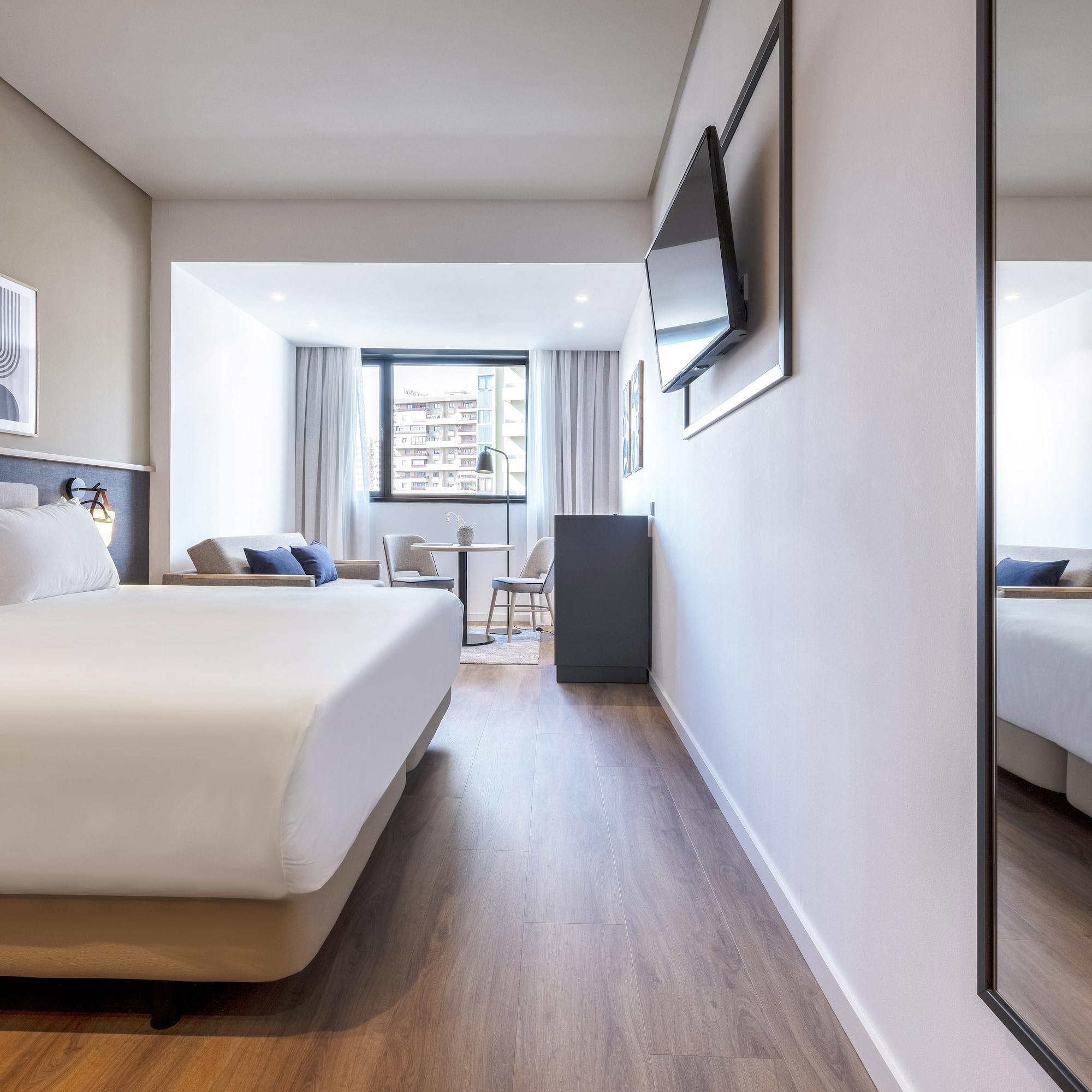 a room with a large mirror and a bed