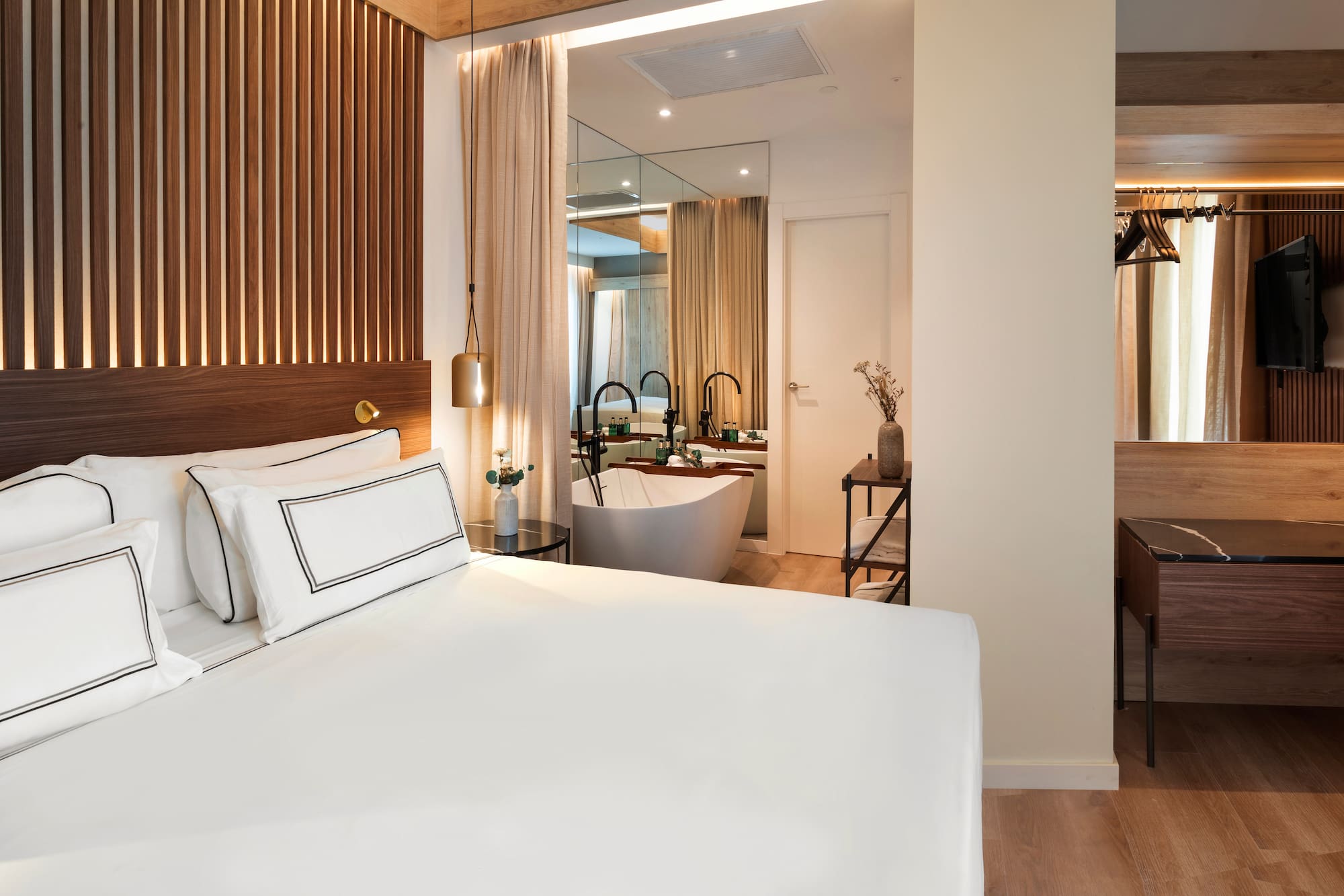 a bedroom with a bathtub and a bed