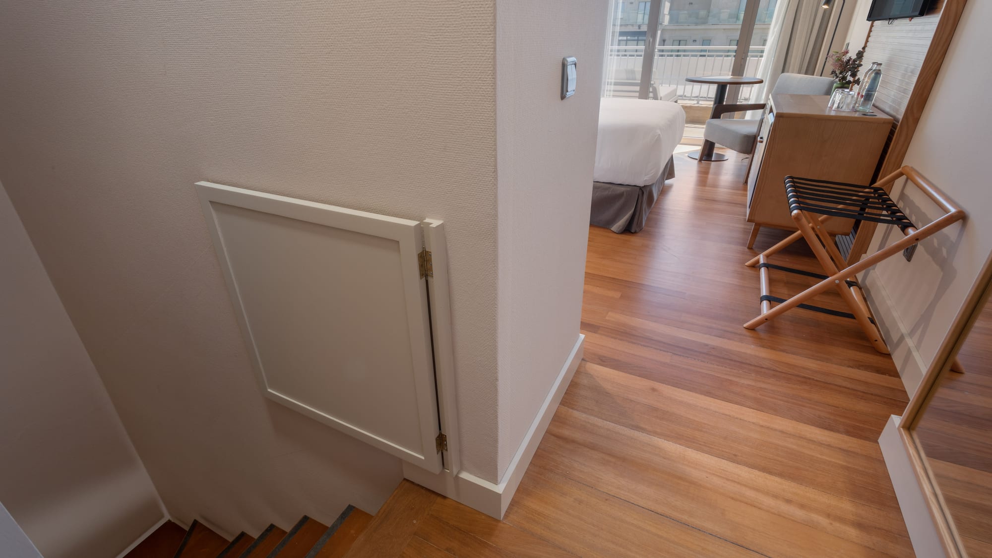 a room with a bed and stairs