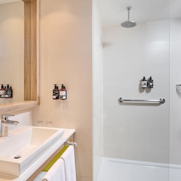 a bathroom with a shower and sink