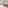 Bright hotel room with twin beds, balcony, table, chairs, and minibar.