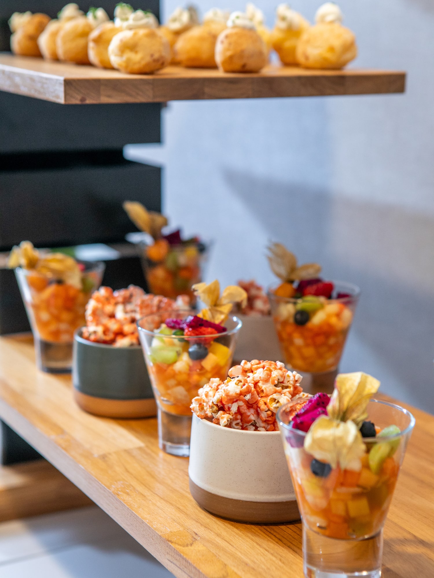 a group of glasses of fruit and popcorn