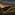 Sunset illuminates vineyard rows, green grapevines, rolling hills, and cloudy sky.