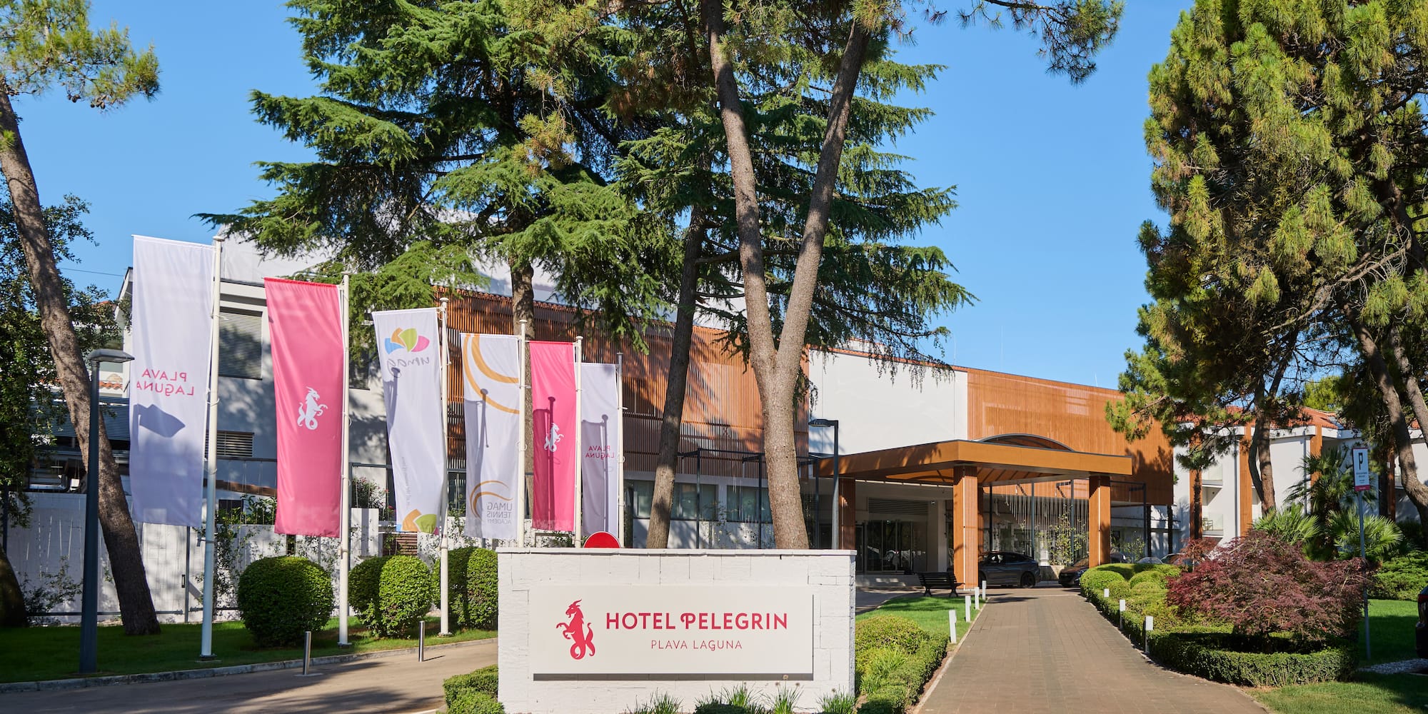 a sign with flags in front of a building