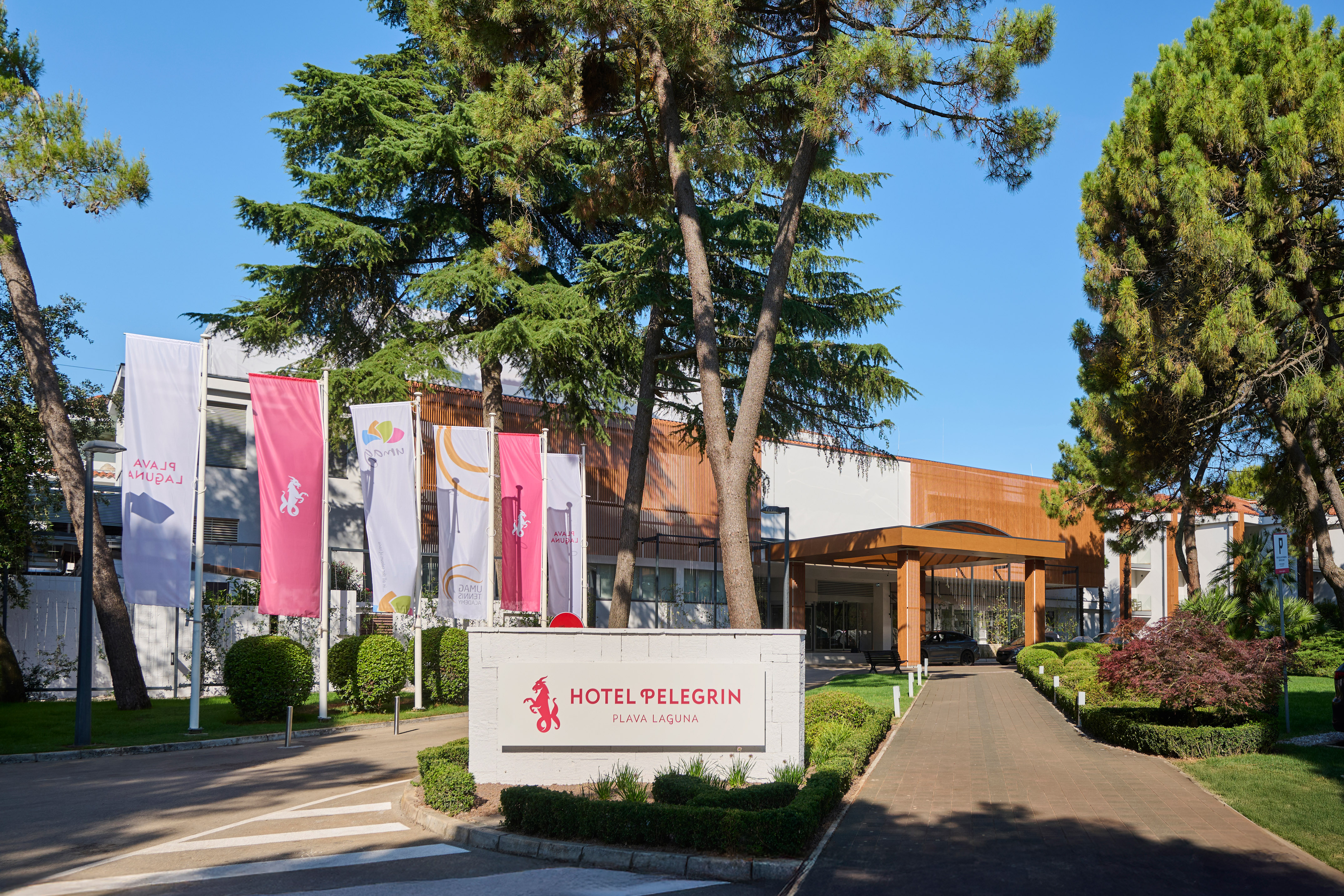 a sign with flags in front of a building