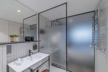 a bathroom with a shower and sink