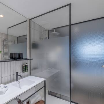 a bathroom with a shower and sink