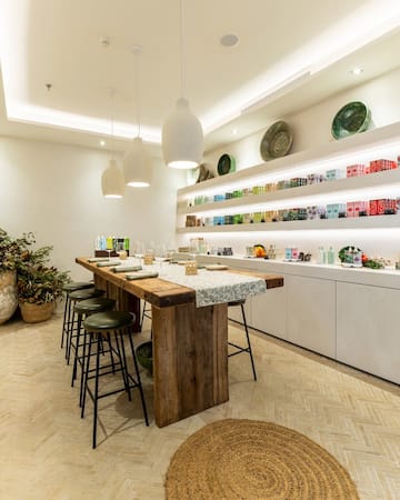 a table with stools and plates on shelves