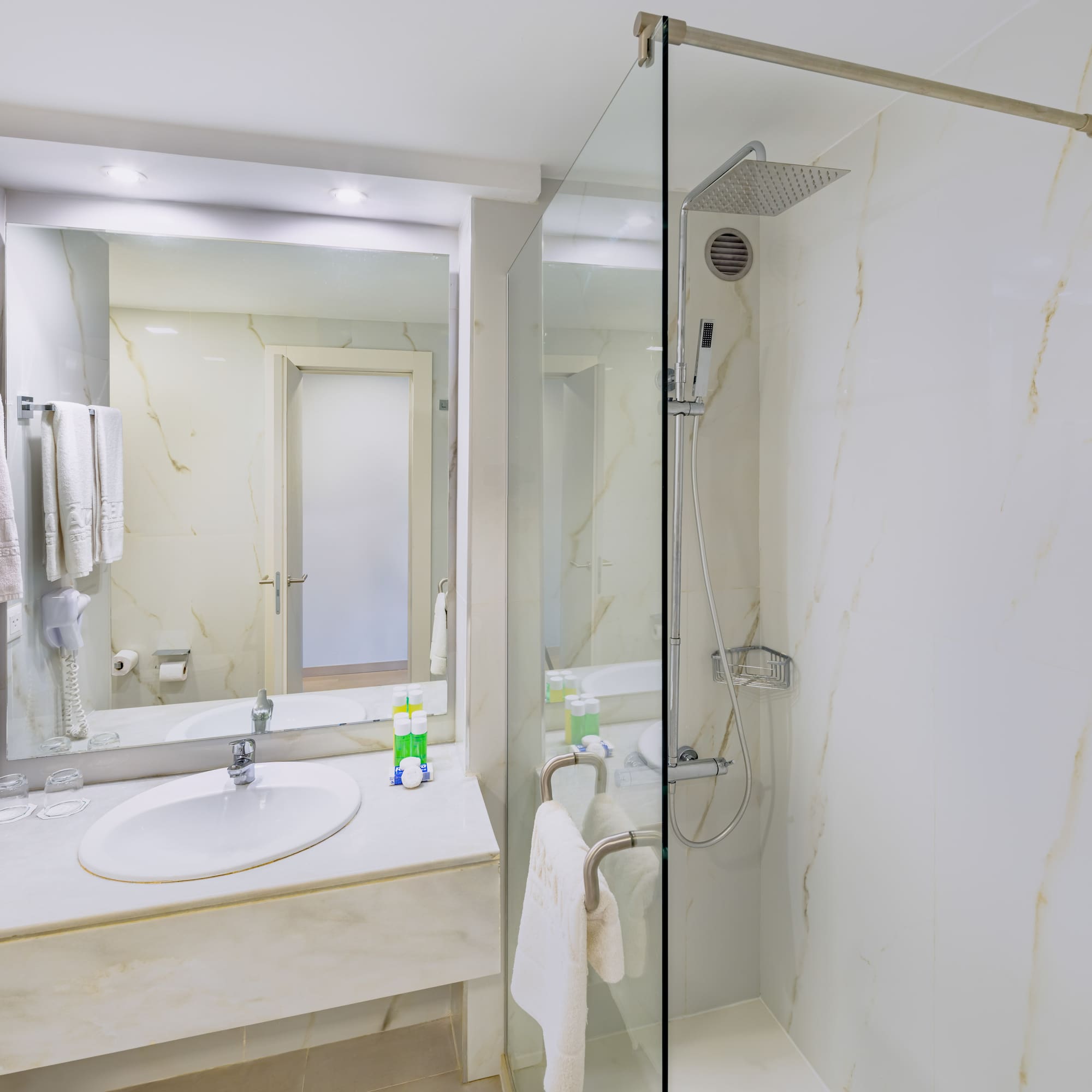 a bathroom with a glass shower and sink