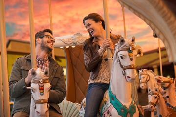a man and woman on a carousel