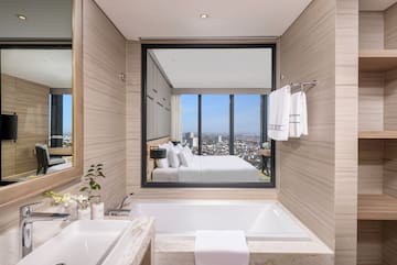 a bathroom with a large window and a bathtub