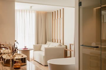 a room with a couch and bathtub