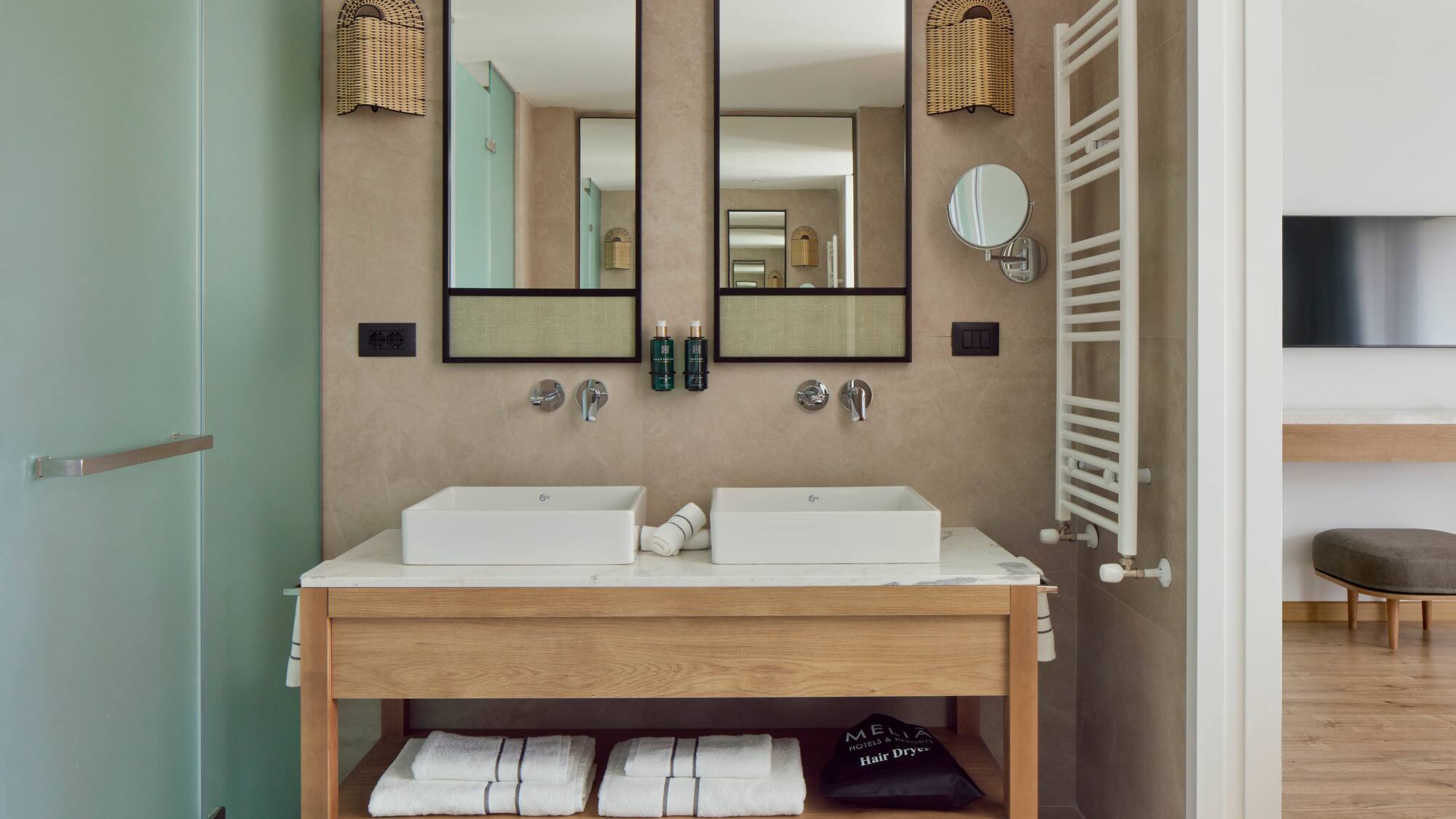 a bathroom with two sinks and mirrors