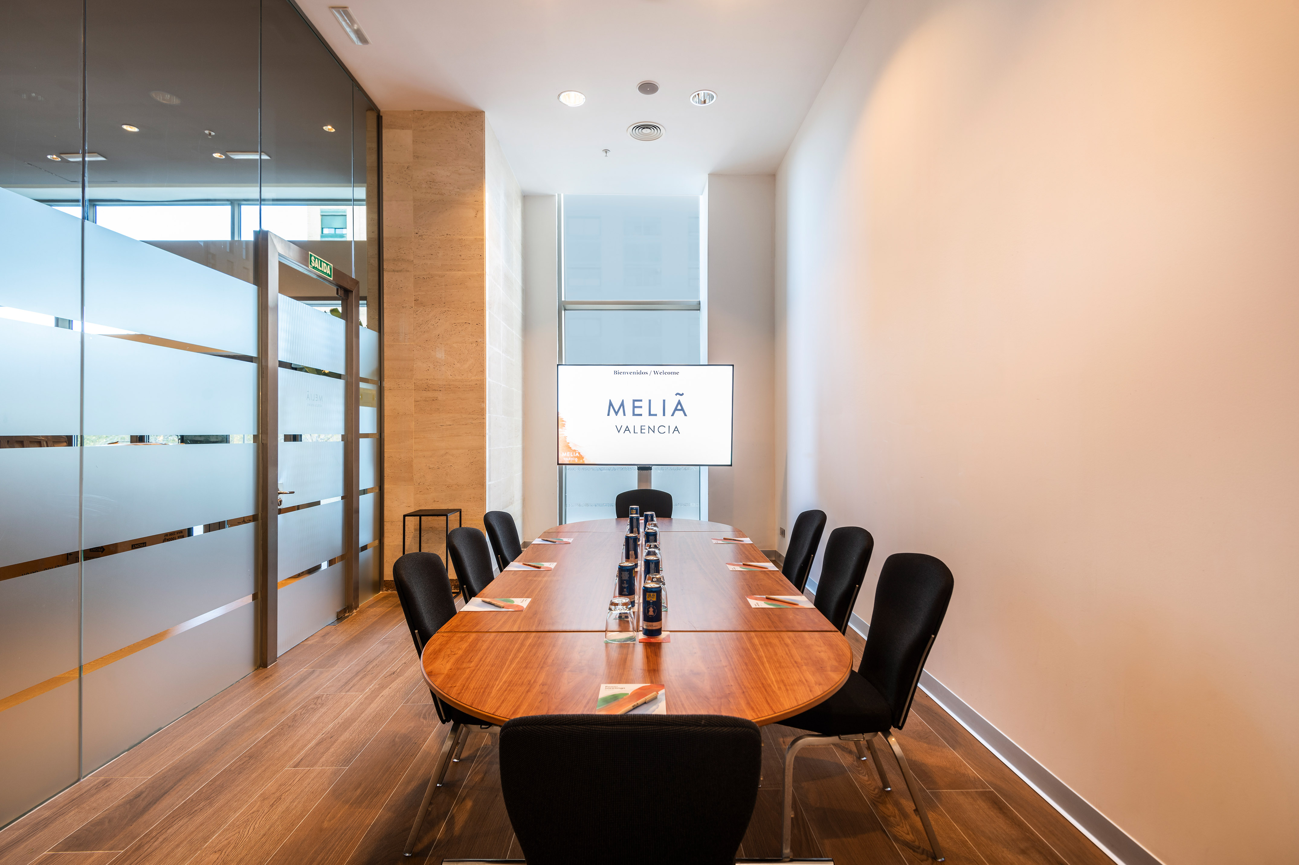 Melia Valencia meeting room with modern oval table and large display screen.