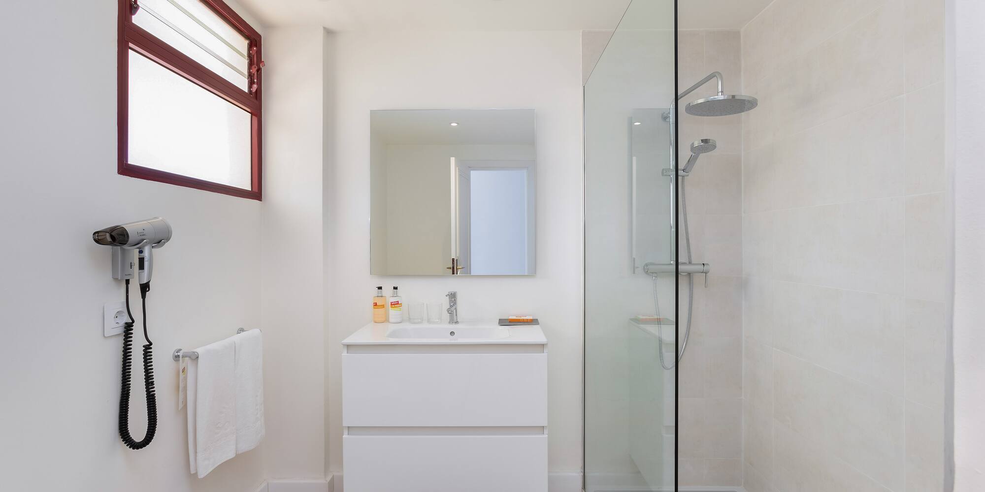 a bathroom with a glass shower and sink