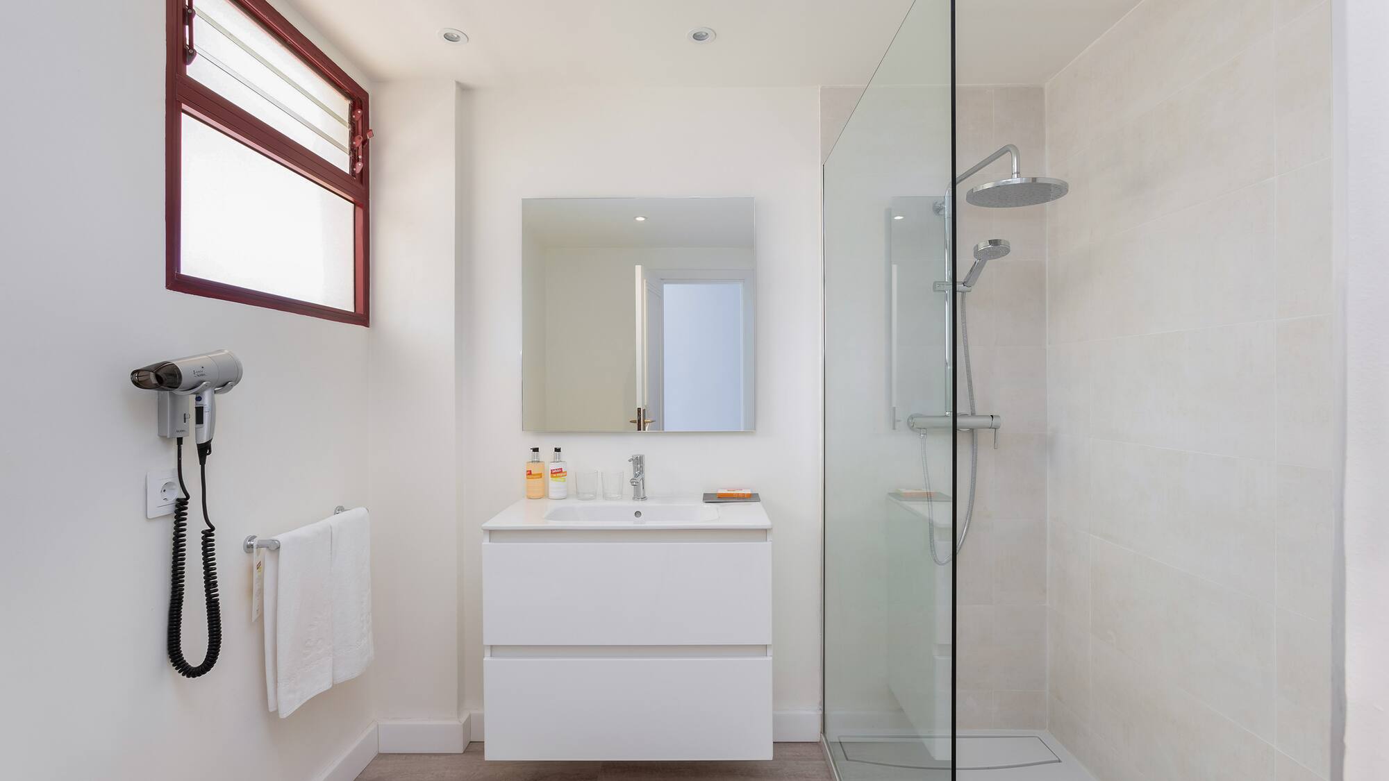 a bathroom with a glass shower and sink