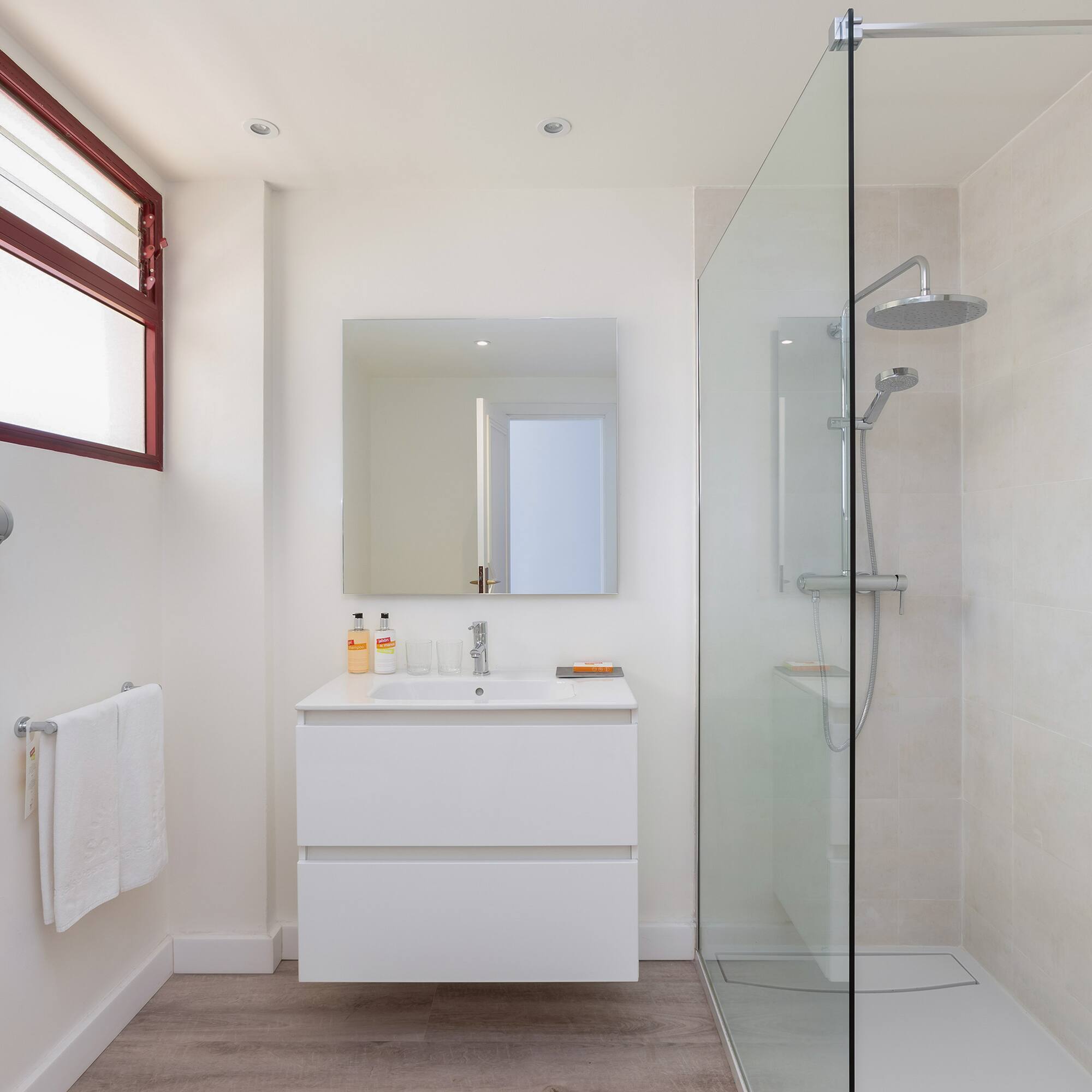 a bathroom with a glass shower and sink