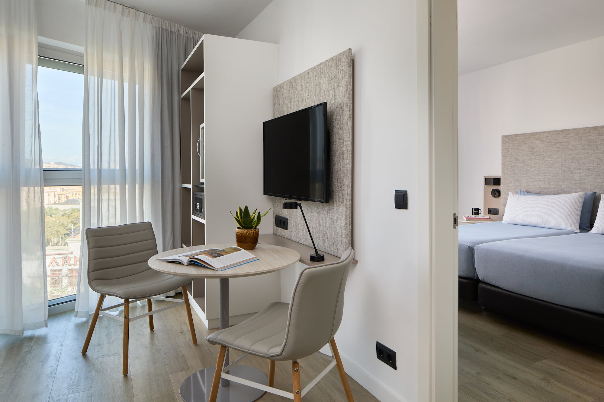 a room with a table and chairs and a tv