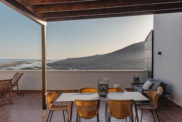 a patio with a table and chairs