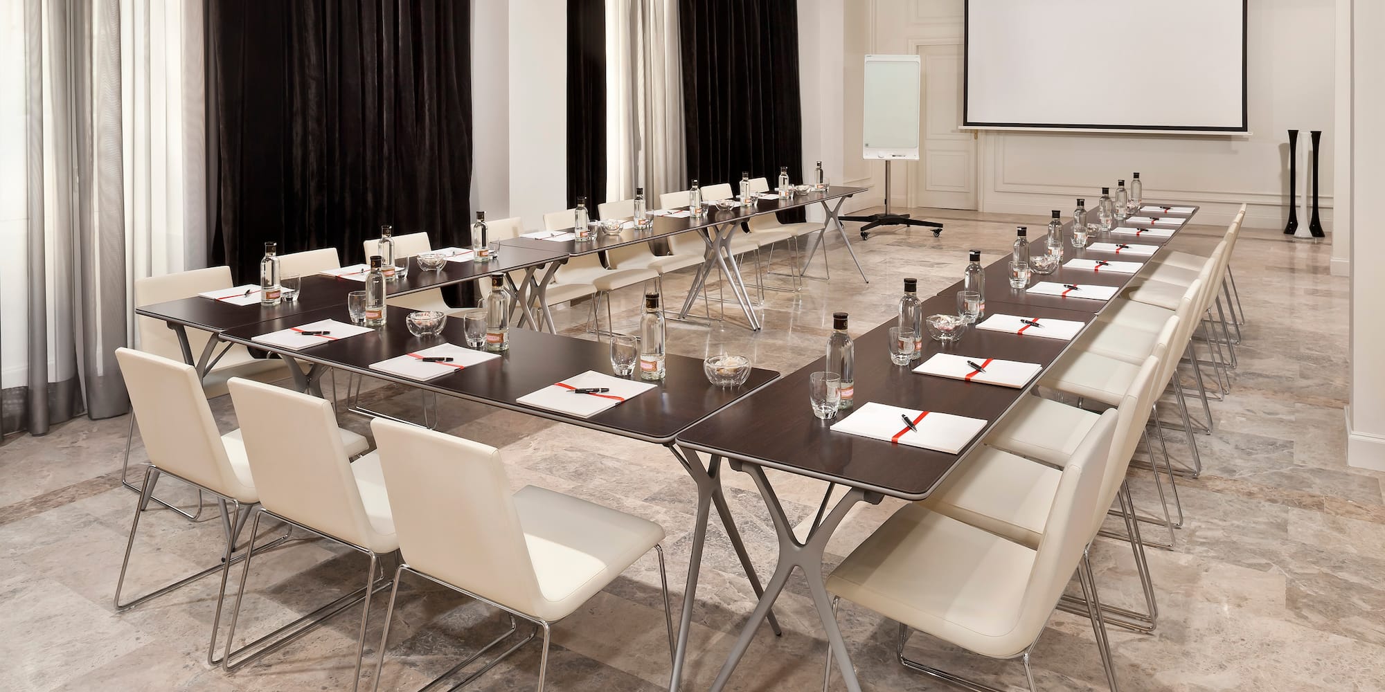 a long conference room with chairs and tables