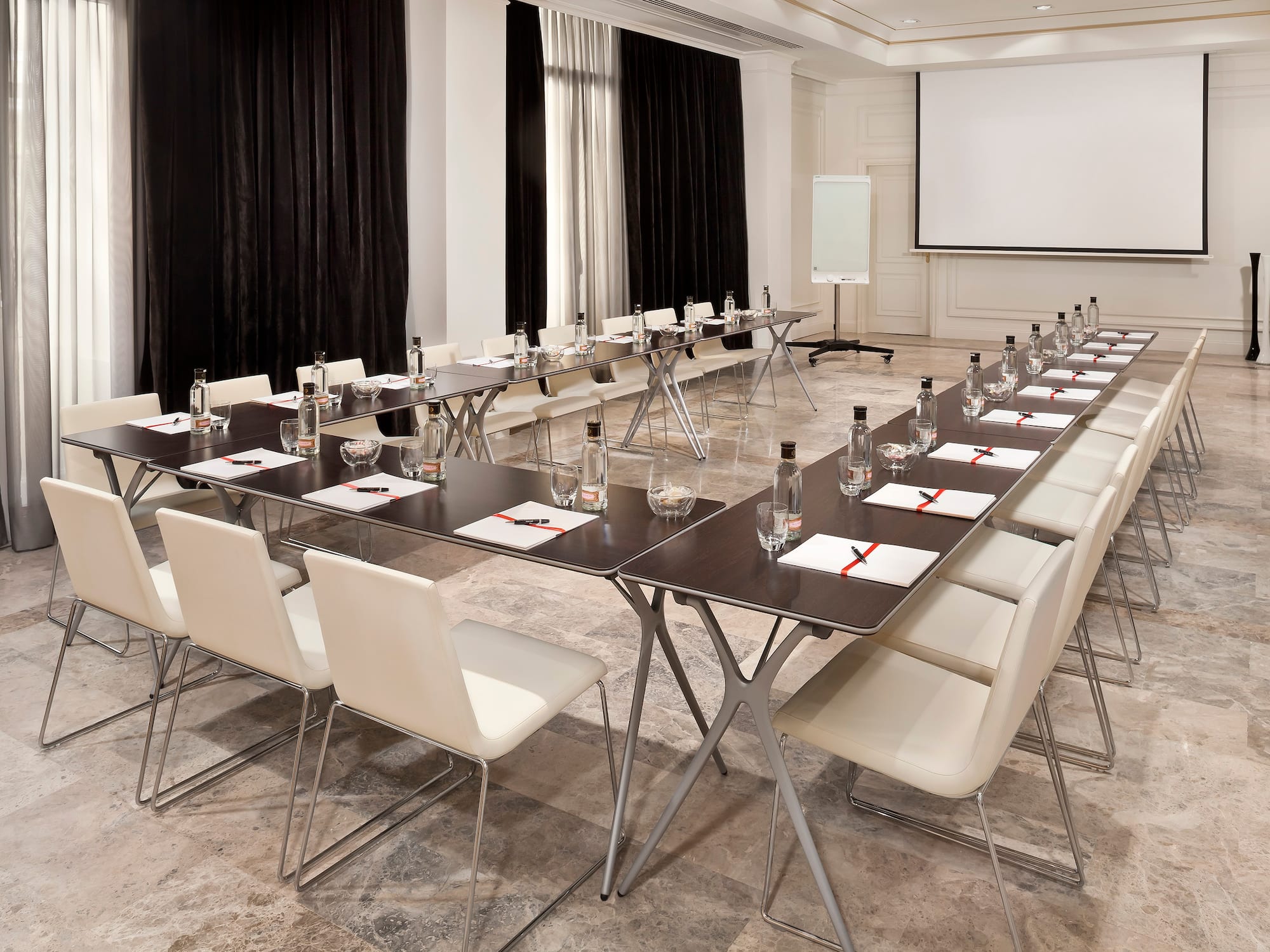 a long conference room with chairs and tables