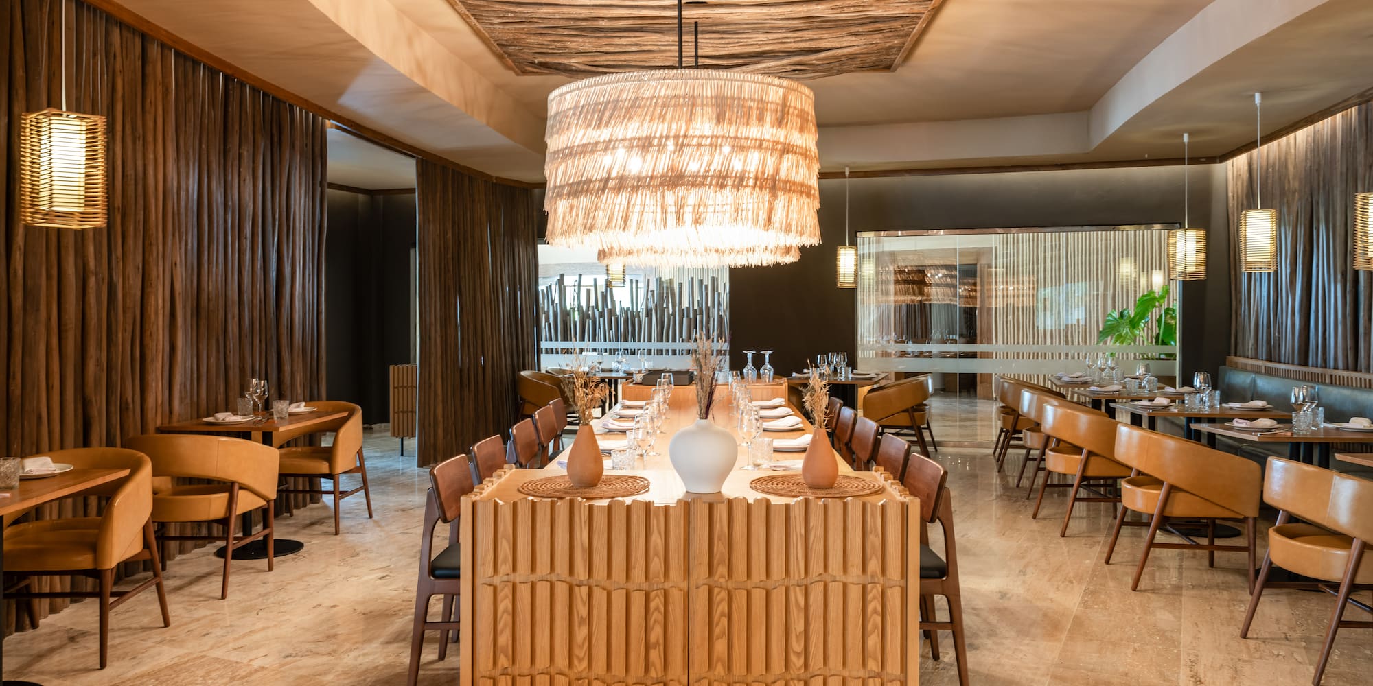 a room with a large chandelier and tables