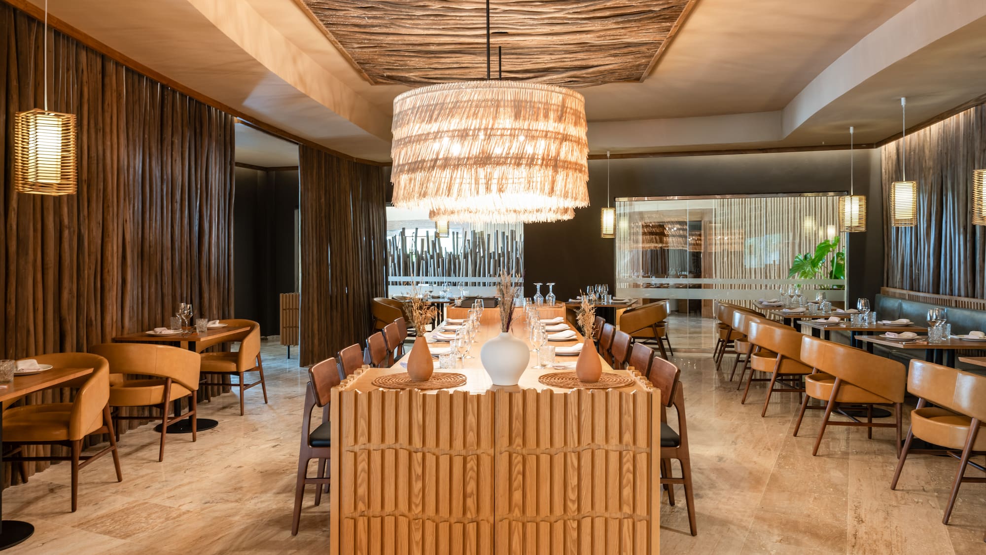 a room with a large chandelier and tables