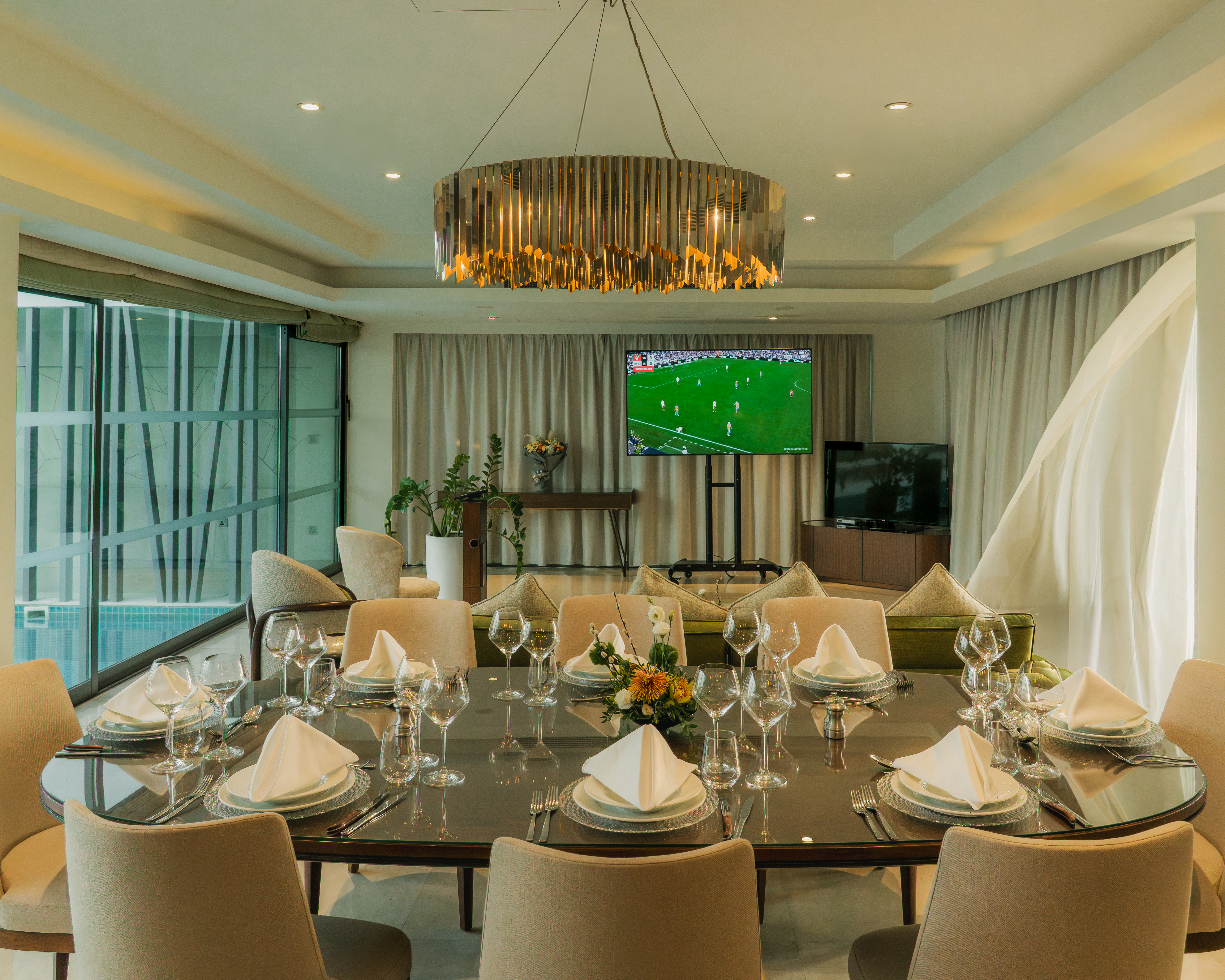 a room with a table set for a dinner party