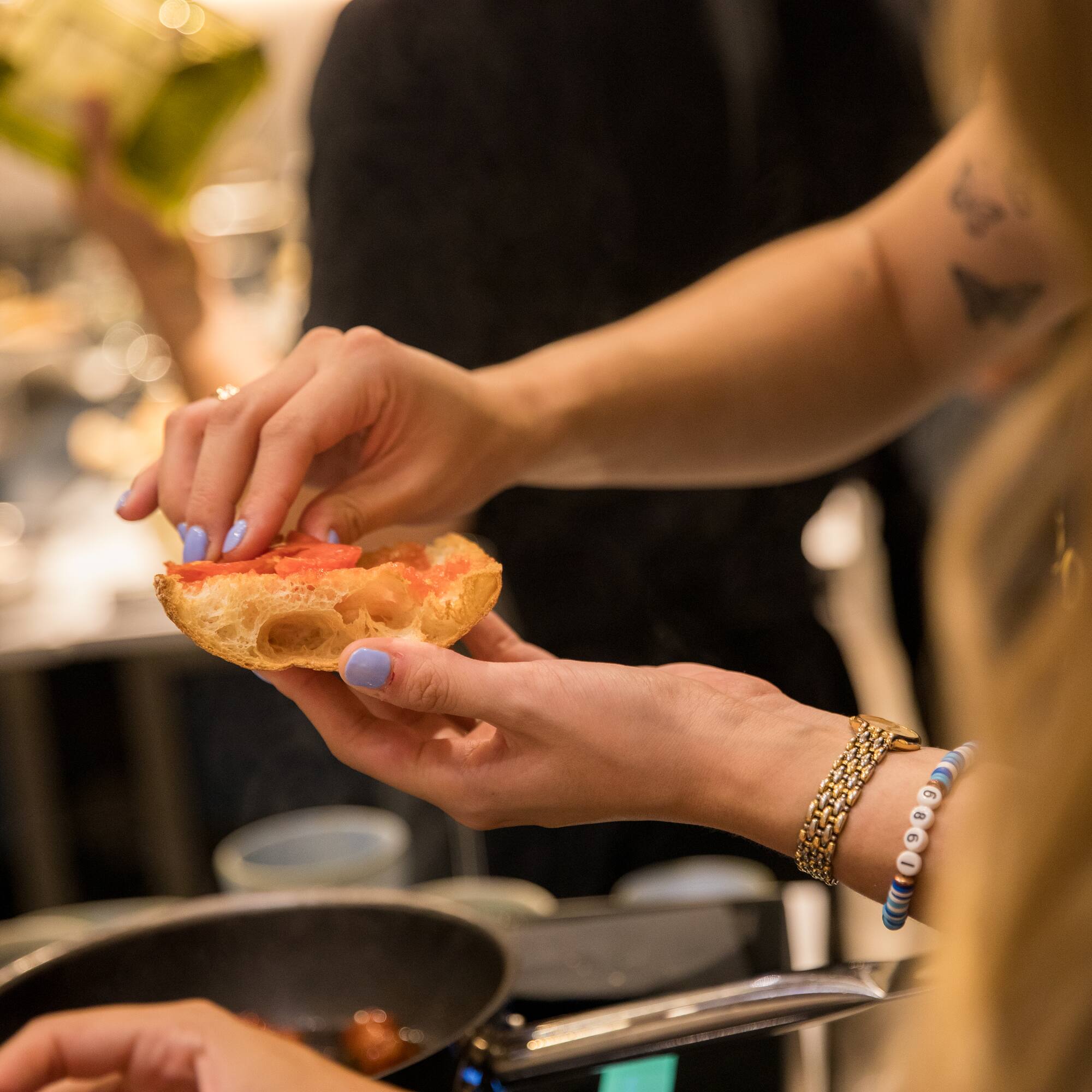 a person holding a piece of bread