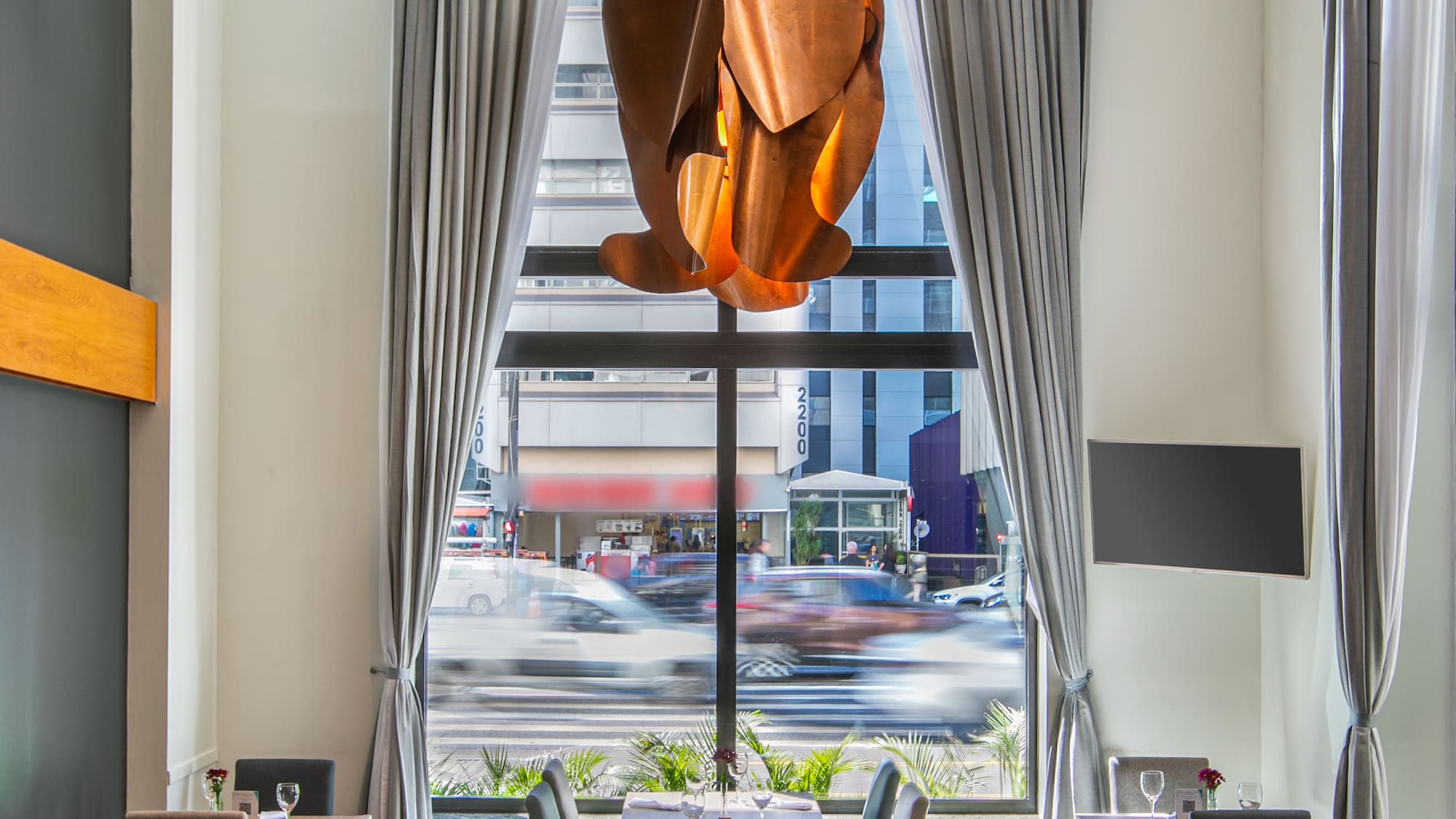 a room with tables and chairs and a chandelier
