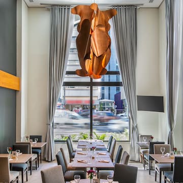 a room with tables and chairs and a chandelier