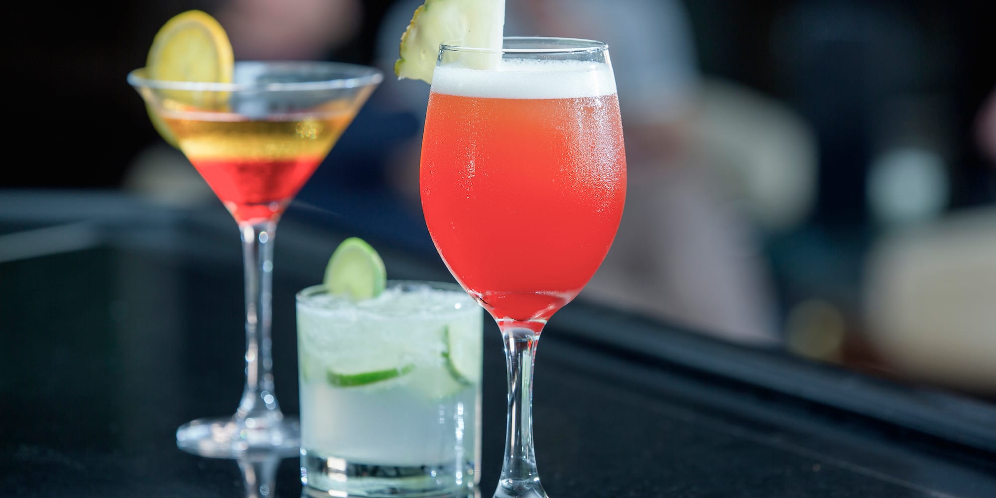 a group of drinks on a bar