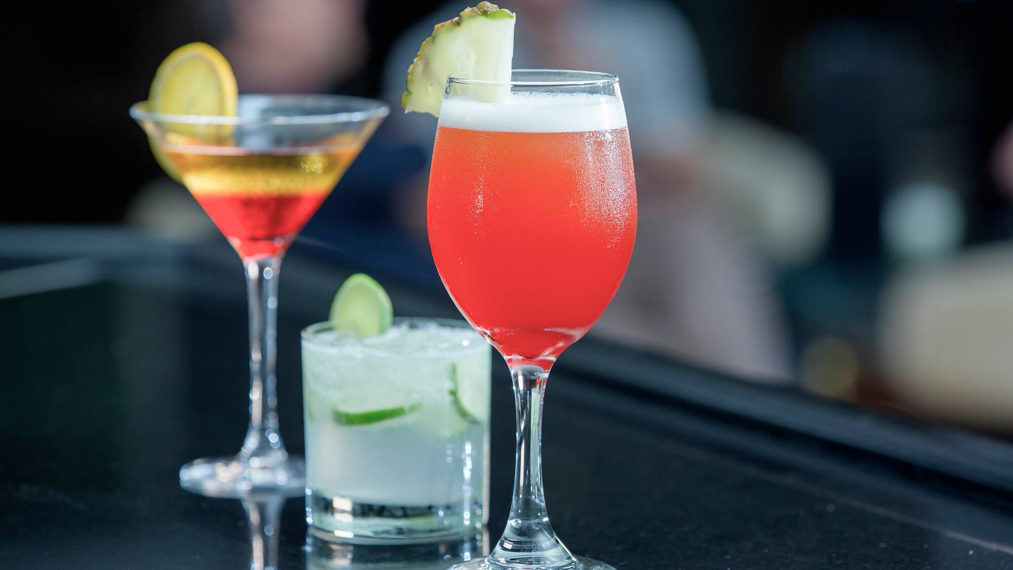 a group of drinks on a bar