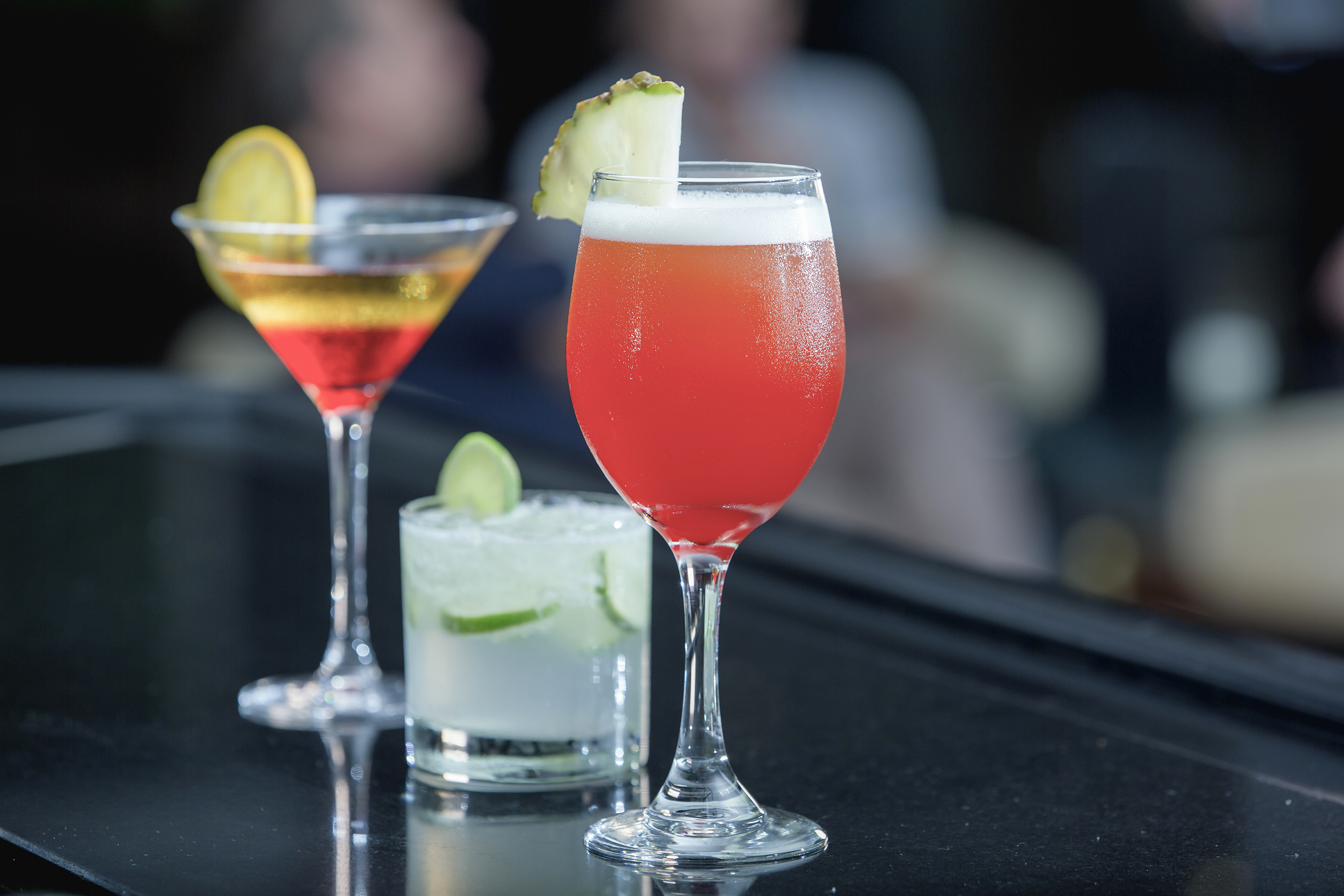 a group of drinks on a bar