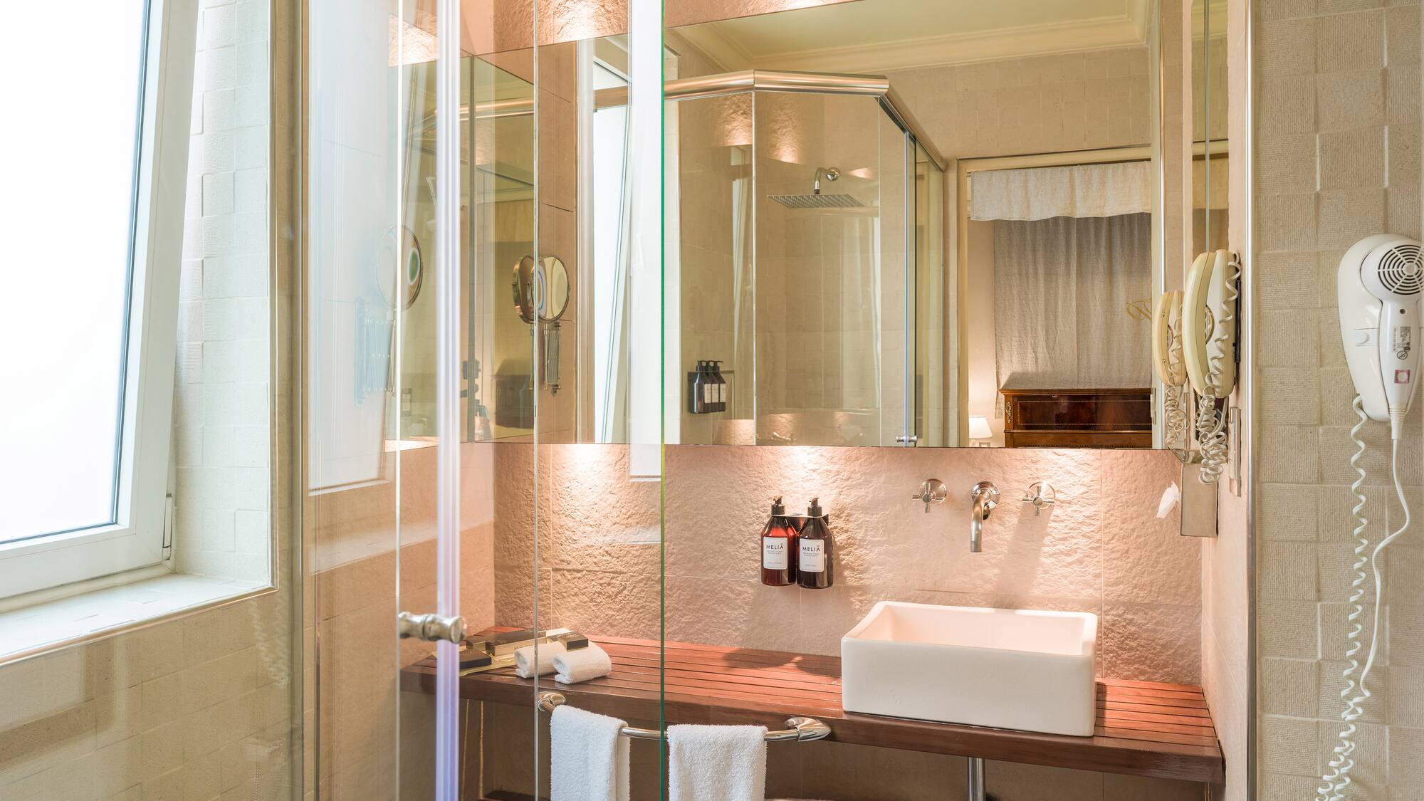 a bathroom with glass shower doors