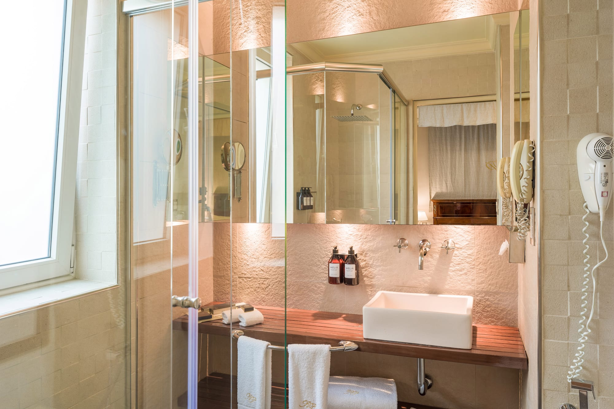 a bathroom with glass shower doors