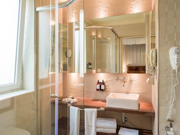 a bathroom with glass shower doors