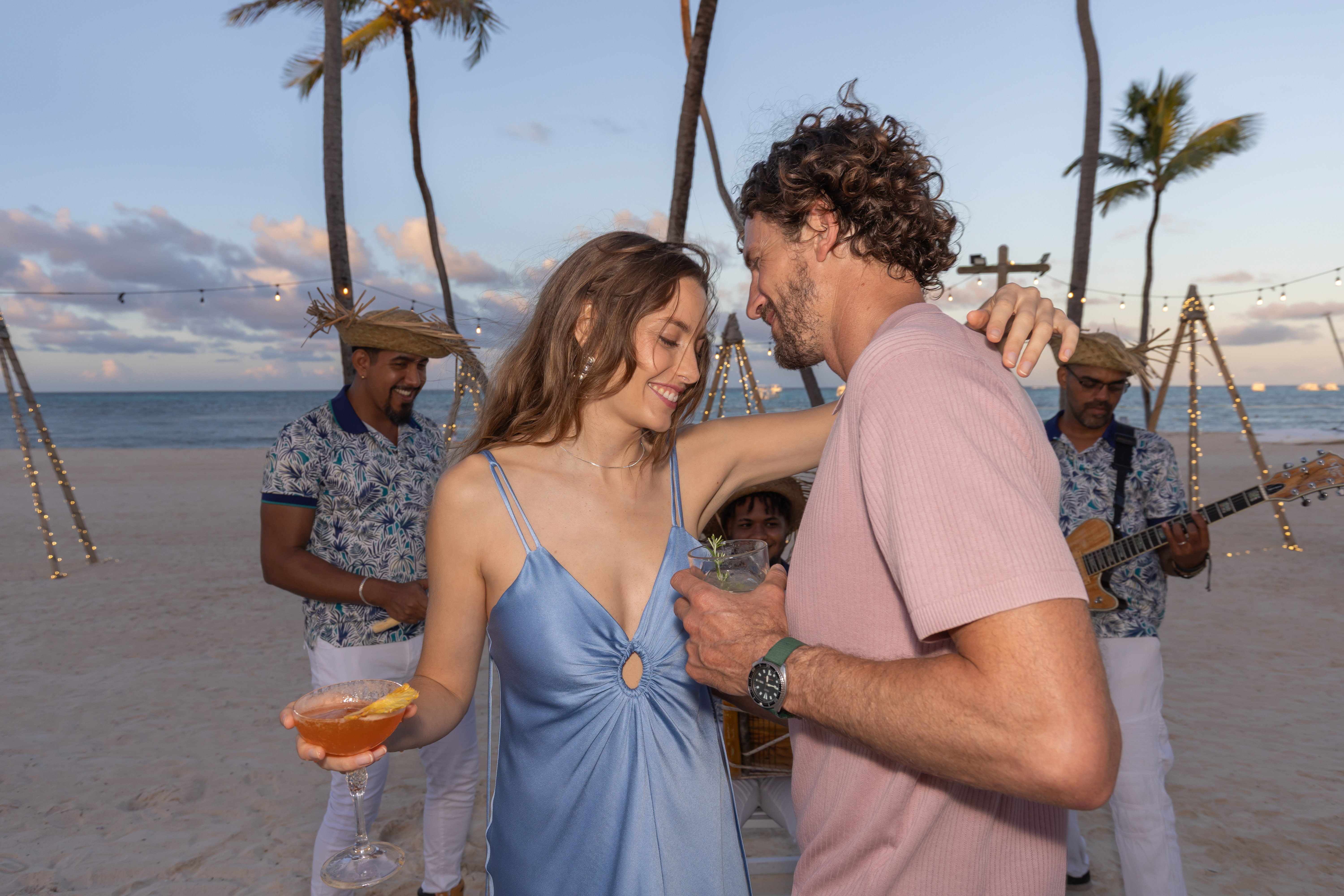 a man and woman standing on a beach